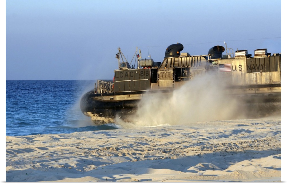 An assault craft heads back to sea after dropping off cargo during an offload.