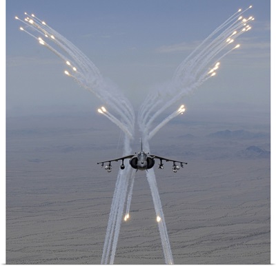 An AV 8B Harrier fires flares during a training flight