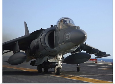 An AV-8B Harrier launches from the flight deck of USS Peleliu