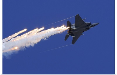 An F-15E Strike Eagle releases flares