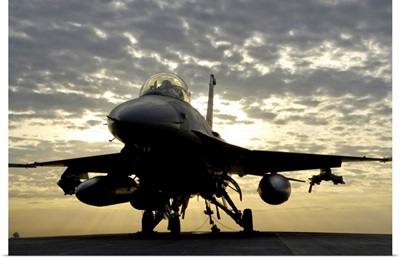 An F-16 Fighting Falcon sits tethered to the hot cargo pad at Joint Base Balad, Iraq