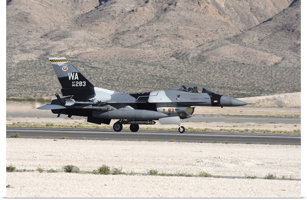 An F-16C Aggressor jet landing on runway in Nevada.