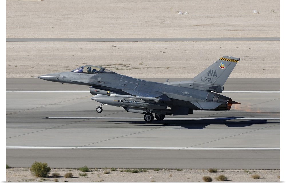 An F-16C Fighting Falcon taking off from Nellis Air Force Base.