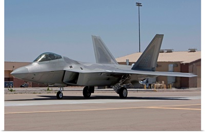 An F-22 Raptor taxies to the runway for a training mission