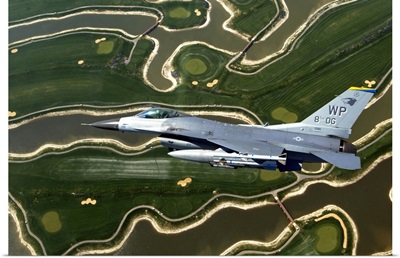 An F16 Fighting Falcon flies near base