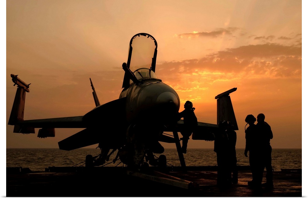 Persian Gulf, October 31, 2011 - An F/18C Hornet aboard USS George H.W. Bush during sunrise.