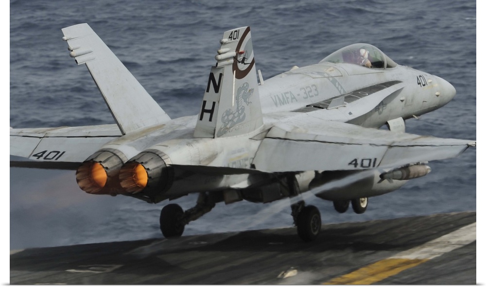 Gulf of Oman, July 1, 2013 - An F/A-18C Hornet launches off the flight deck of the aircraft carrier USS Nimitz.
