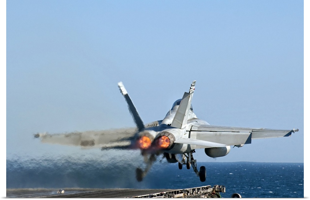 A US Navy F/A-18F Super Hornet launches from the flight deck of aircraft carrier USS Nimitz.