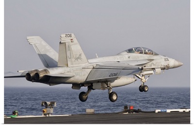An F/A-18F Super Hornet launches off the flight deck of USS George H.W. Bush