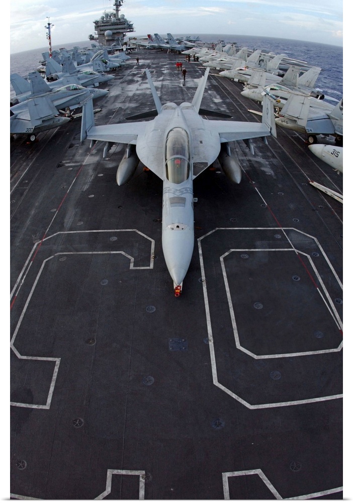 An F/A-18F Super Hornet of Strike Fighter Squadron 102 parked on the bow of the USS Kitty Hawk.