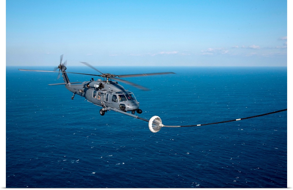 Pacific Ocean, March 18, 2011 - An MC-130P Combat Shadow refuels a HH-60 Pave Hawk helicopter. The refueling missions are ...