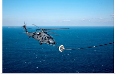 An HH-60 Pave Hawk refuels over the Pacific Ocean