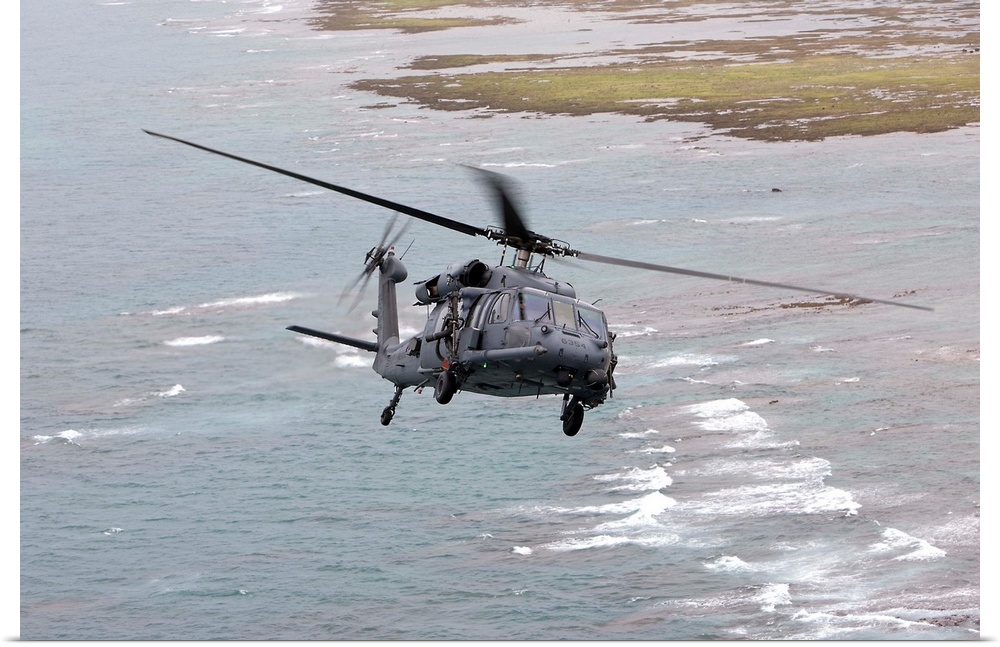 An HH-60G Pave Hawk from the 33rd Rescue Squadron flies along the Okinawa coastline during a training mission out of Kaden...