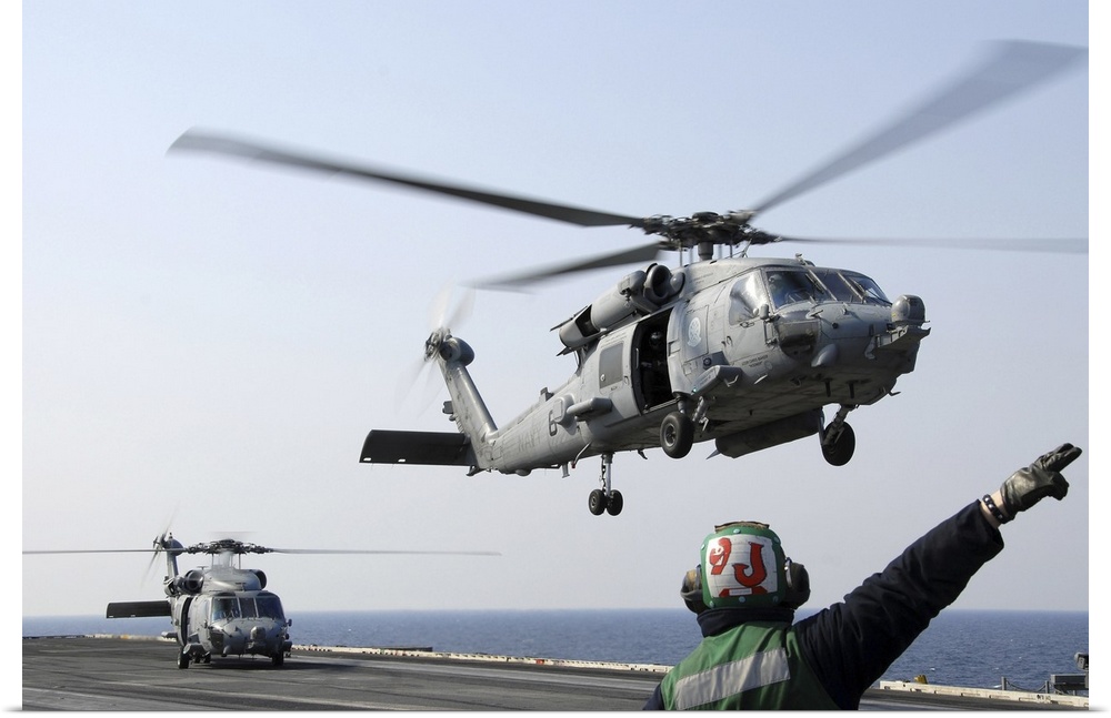 Pacific Ocean, March. 13, 2011 - An HH-60H Sea Hawk helicopter launches from the aircraft carrier USS Ronald Reagan (CVN-7...