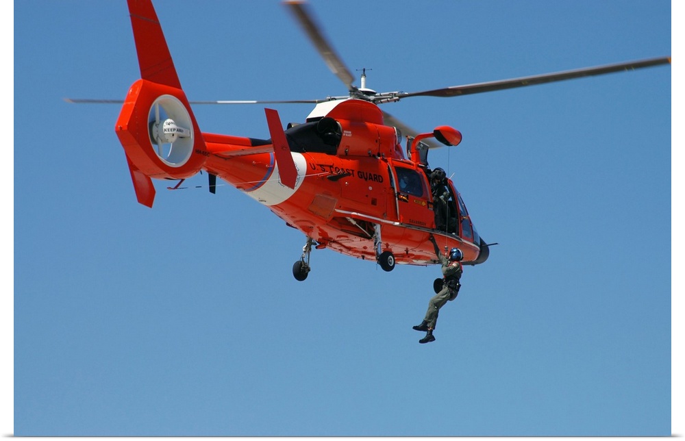 Members of the US Coast Guard (USCG) Savannah Station use a USCG HH-65C Dolphin Short Range Recovery Helicopter to demonst...