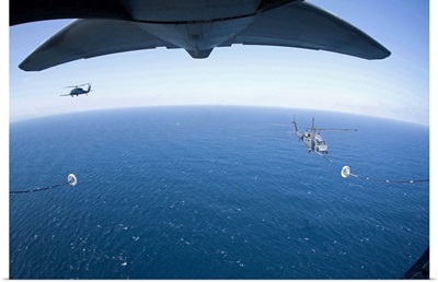 An MC-130P Combat Shadow prepares to refuel two HH-60G Pave Hawk helicopters