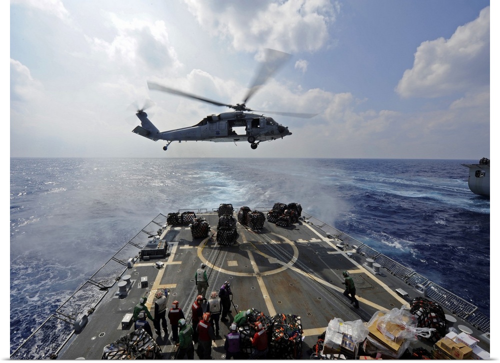 South China Sea, October 25, 2011 - An MH-60R Sea Hawk helicopter transfers supplies to the flight deck of the Arleigh Bur...