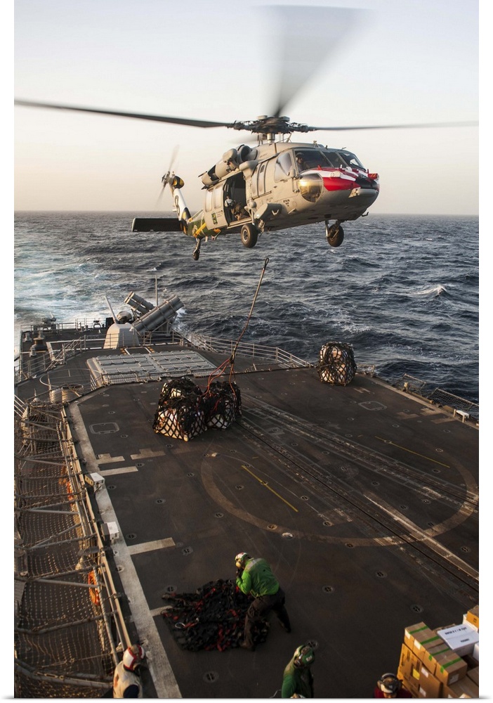 February 16, 2013 - An MH-60S Sea Hawk helicopter delivers cargo to the Ticonderoga-class guided-missile cruiser USS Mobil...