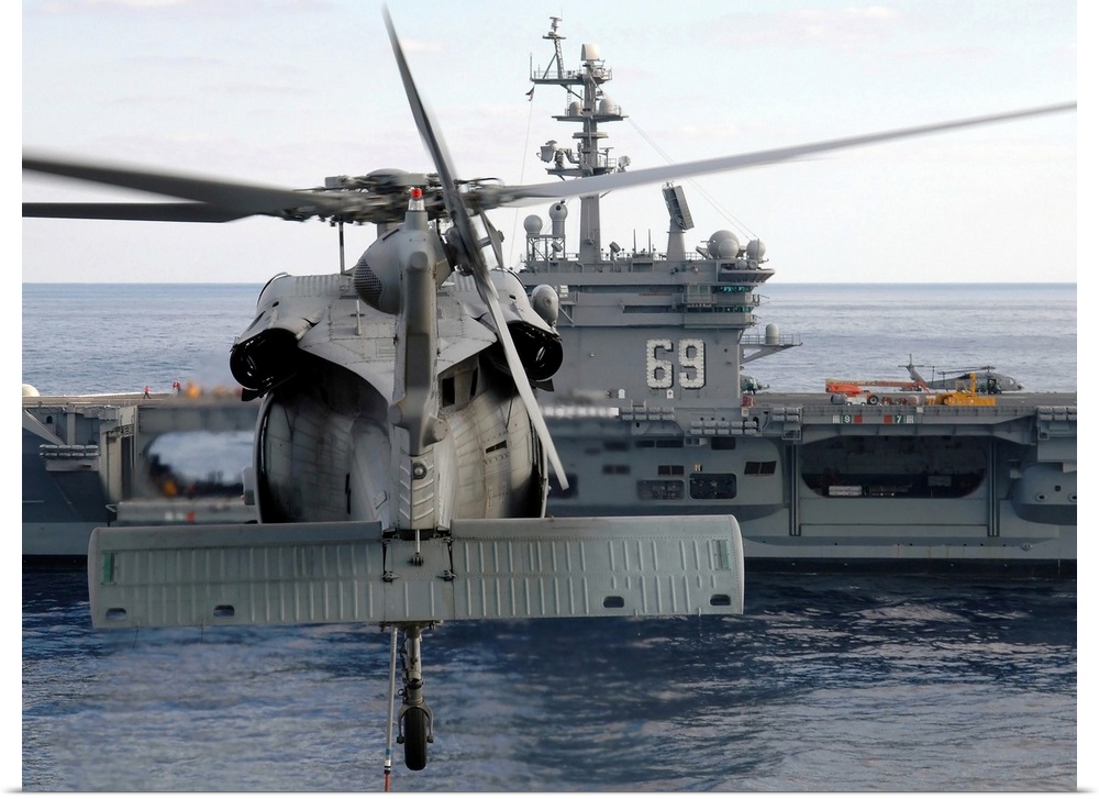 Atlantic Ocean, November 5, 2005 - An MH-60S Seahawk helicopter hovers prior to taking a load of ammunition to the Nimitz-...