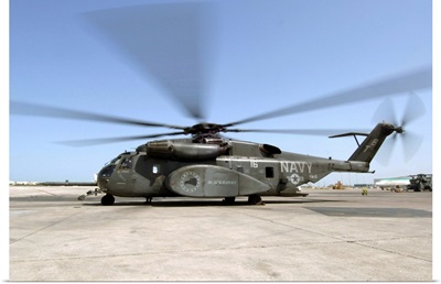 An MH53E Sea Dragon helicopter sits ready on the flight line