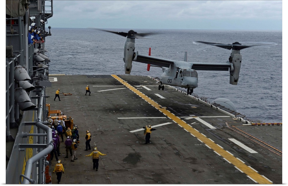 South China Sea, February 19, 2014 - An MV-22 Osprey tiltrotor aircraft prepares to land on the flight deck of the amphibi...
