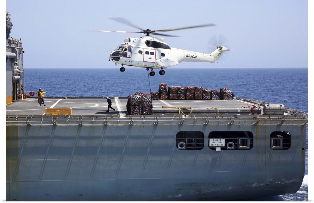 Gulf of Oman, September 5, 2013 - An SA-330J Puma helicopter approaches the dry cargo and ammunition ship USNS Cesar Chave...