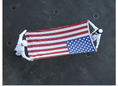 Aviation Ordnancemen Fold The American Flag Aboard USS Theodore Roosevelt