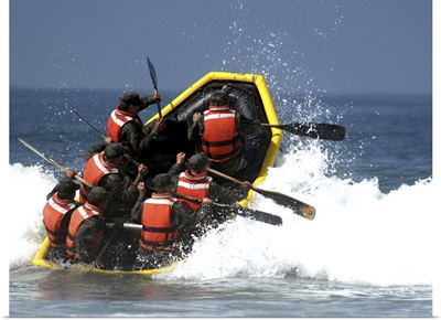 Basic Underwater Demolition/SEAL students battle through the surf