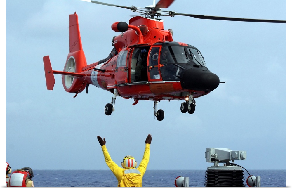 Pacific Ocean, November 30, 2007 - Boatswain Mate directs a Coast Guard HH-65A Dolphin aboard the guided-missile destroyer...