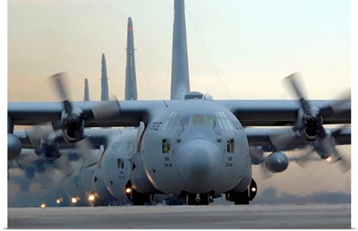 C130 Hercules aircraft taxi out for a mission during a sixship sortie