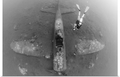 Diver explores the wreck of a Mitsubishi Zero fighter plane