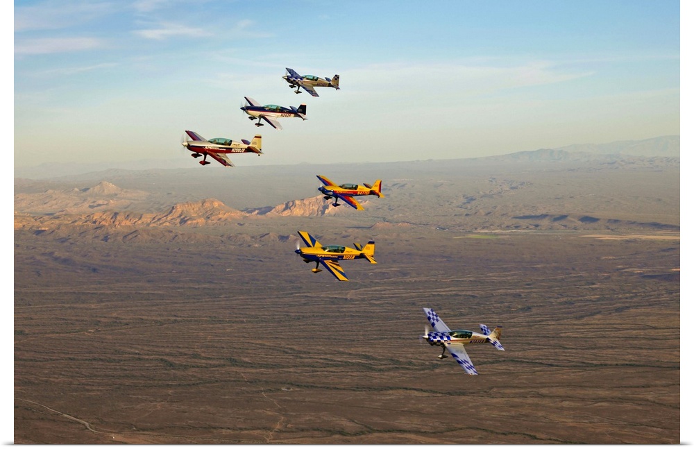 Extra 300 aerobatic aircraft fly in formation during APS training in Mesa, Arizona.