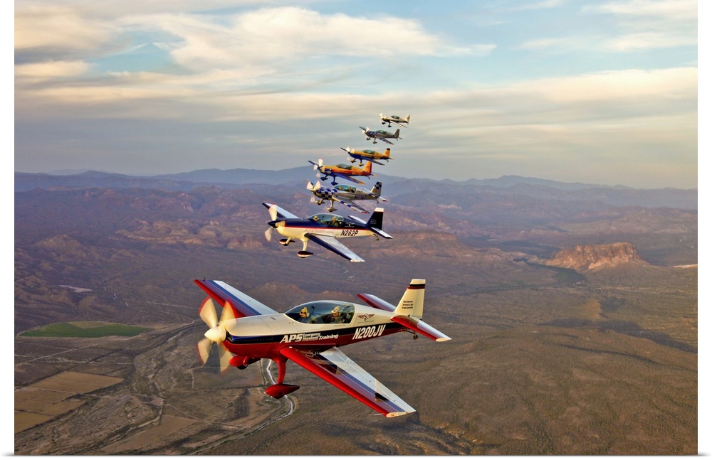 Extra 300 aerobatic aircraft fly in formation over Mesa, Arizona.