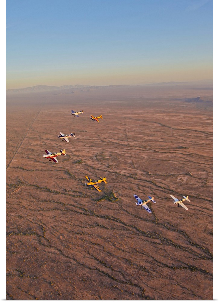 Extra 300 aerobatic aircraft fly in formation over Mesa, Arizona.
