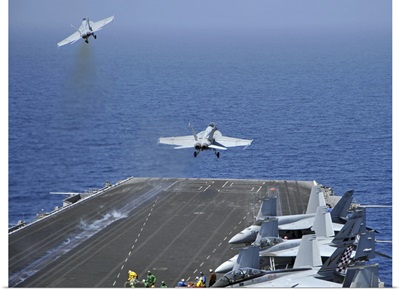 F/A-18F Super Hornets launch from the aircraft carrier USS Enterprise
