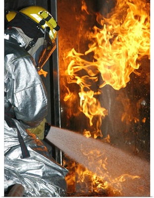 Firefighter Extinguishes A Simulated Structural Fire