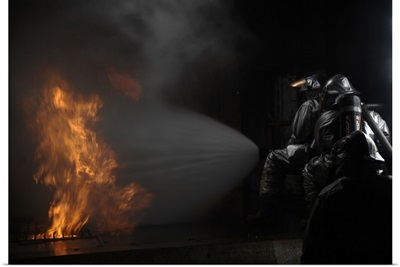 Firefighters extinguish a simulated cargo fire at RAF Mildenhall, England