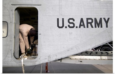 Flight Engineer Secures Equipment Inside Of His C-23B Sherpa Aircraft