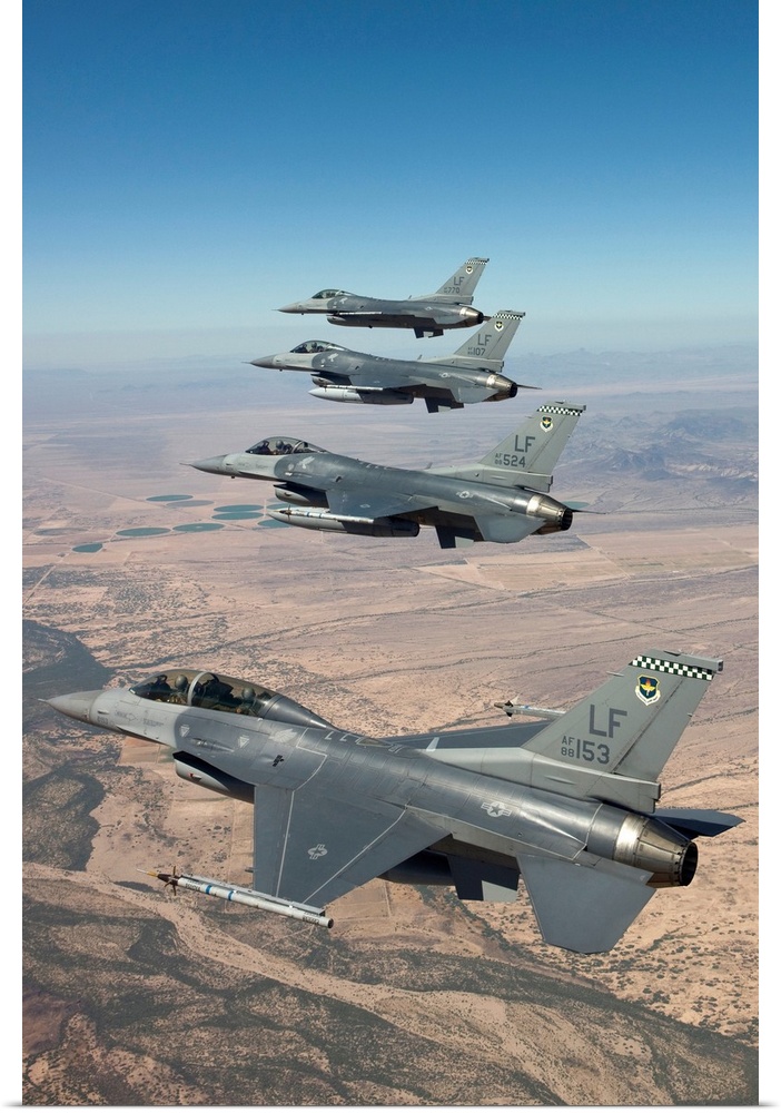 Four F-16's from the 56th Fighter Wing at Luke Air Force Base, Arizona, manuever on a training mission over the Arizona de...