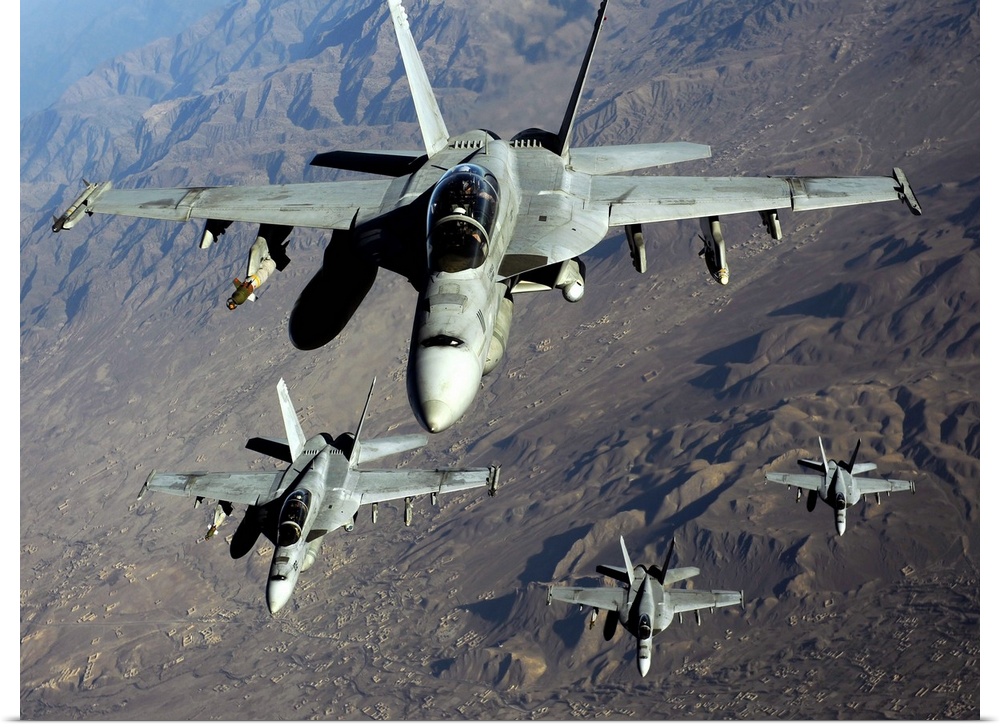 November 25, 2010 - Four U.S. Navy F/A-18 Hornet aircraft fly over mountains in Afghanistan.