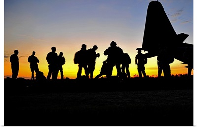 Green Berets prepare to board a KC-130 aircraft