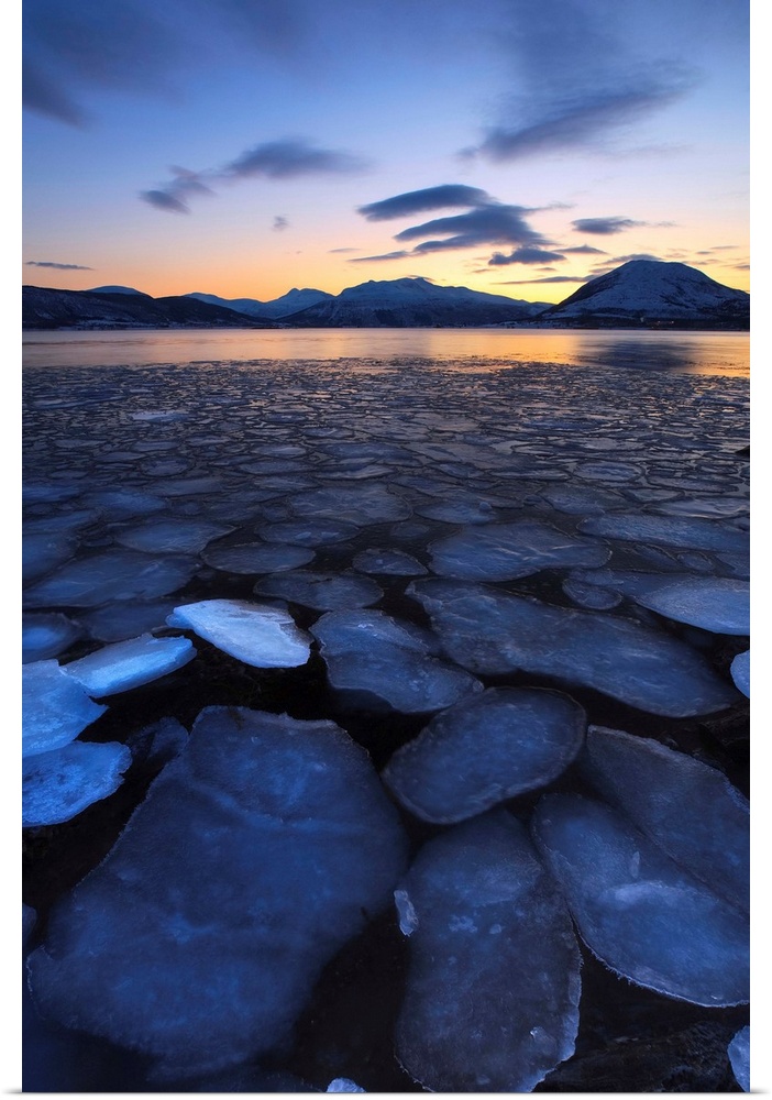 A rare sight in Tjeldsundet, Troms County, Norway. Ice flakes drifting in the sunset looking towards the mountains on Tjel...