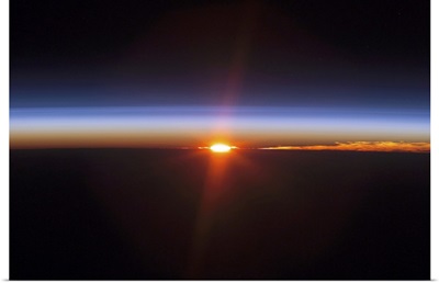 Layers of Earths atmosphere brightly colored as the sun sets over South America