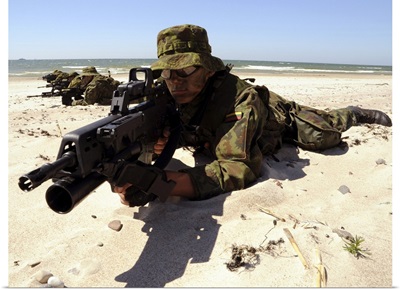 Lithuanian Special Forces Members Lie In Formation On A Beach