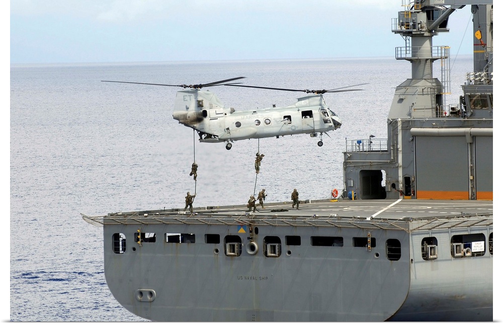 Philippine Sea, September 18, 2010 - Marines embarked aboard the amphibious assault ship USS Essex, fast rope from a CH-46...