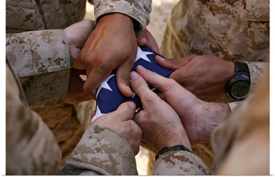 Marines fold an American flag