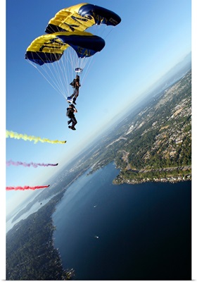 Members of the US Navy Parachute Team the Leap Frogs perform a biplane