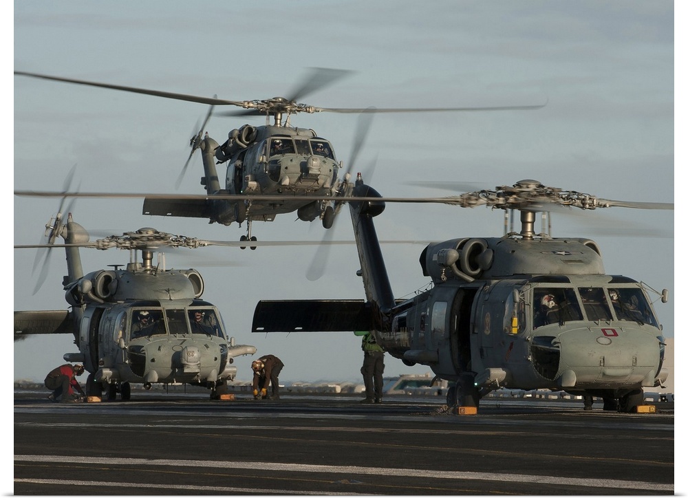 Pacific Ocean, December 21, 2011 - SH-60F and HH-60H Sea Hawk helicopters land on the flight deck aboard the Nimitz-class ...