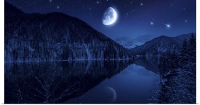 Moon rising over tranquil lake in the misty mountains against starry sky
