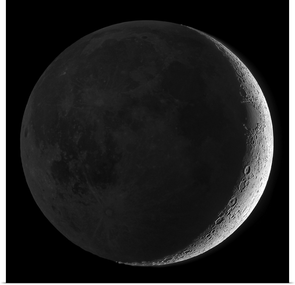 Giant square wall picture of the moon, dark except a small sliver on one side, surrounded by a black background.